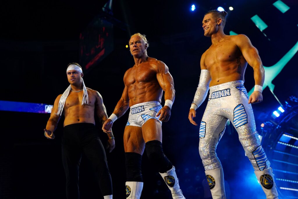The Gunn Club (Billy, Colten and Austin Gunn) standing on stage at AEW Dynamite