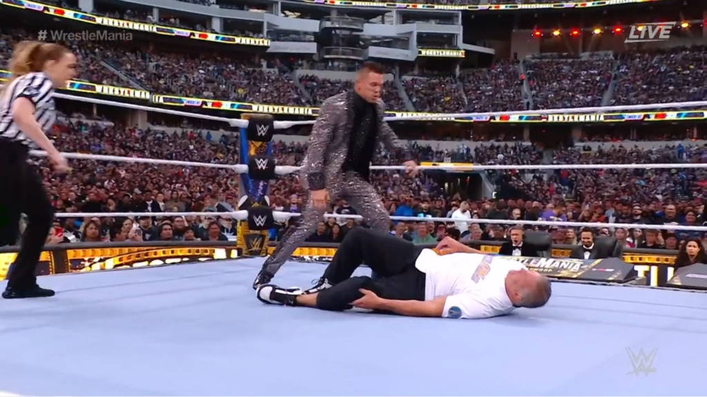 Shane McMahon lies on the mat after suffering a knee injury against The Miz at WrestleMania 39